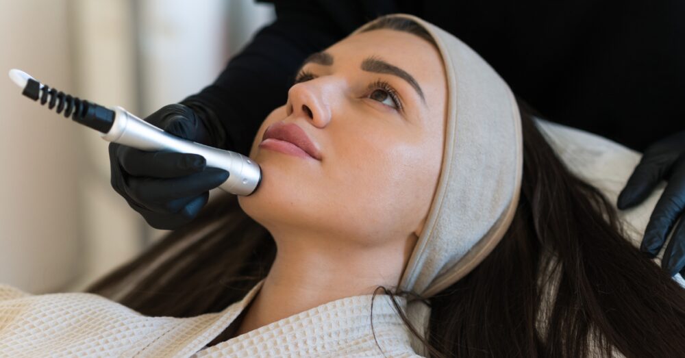 Provider using a HydraFacial device on a woman’s face