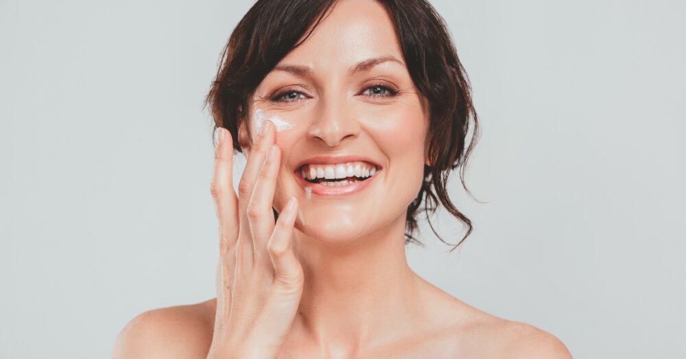 Woman touching the area under her eye while smiling