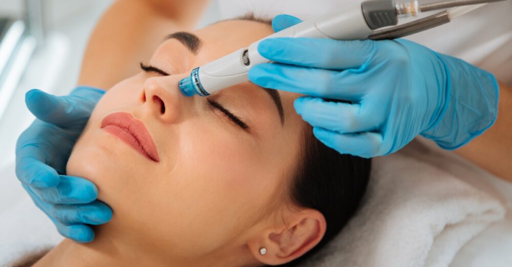 Close up of a woman receiving facial treatment from a gloved provider